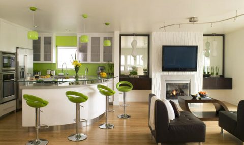 this eco friendly kitchen is green both literally and figuratively.green eco spec paint was used on walls and matched with modular bar stools and glass pendant lights.bamboo floors warm the room and top appliances with custom cabinetry make the room pop.